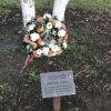 Flowers laid in memory of Derrick by his tree in the grounds of County Hall